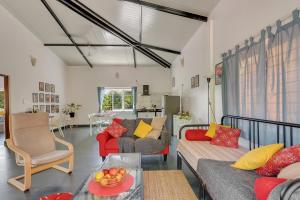 a living room with two couches and a table at Kiki Villa in Arambol