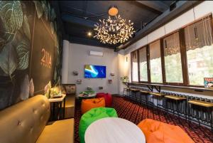 a room with chairs and a table and a chandelier at Hostel 211A in Almaty