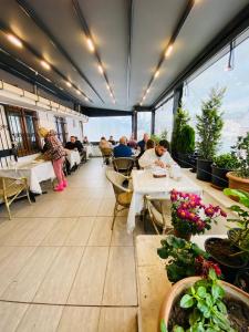 a restaurant with tables and people sitting at tables at RENOVA TURiZM HOTEL in Istanbul