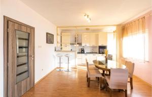 a kitchen and dining room with a table and chairs at Amazing Apartment In Okrug Gornji With House Sea View in Trogir
