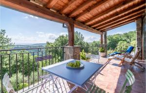 a patio with a blue table and chairs on a balcony at Villa Luca in Vitorchiano