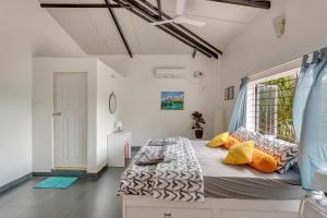 a bedroom with a large bed with a window at Kiki Villa in Arambol