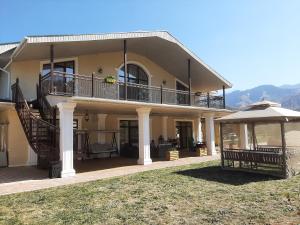 a large house with a balcony and a patio at Mountain Garden & SPA in Besqaynar