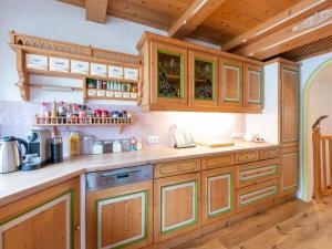 キルヒベルク・イン・チロルにあるHoliday home in Kirchberg with saunaのウッドフロアのキッチン(木製キャビネット付)