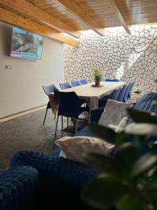 a meeting room with a table and chairs and a wall at San Marzano Rooms in San Marzano sul Sarno
