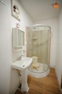 a bathroom with a sink and a shower and a toilet at Vintage Retreat Resort in Bīdar