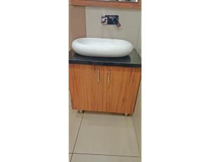 a bathroom with a sink on a counter at Royal Comfort Cottage, Panipat in Pānīpat