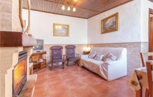 a living room with a couch and a fireplace at Beautiful Home In Cacn granada With 2 Bedrooms, Wifi And Outdoor Swimming Pool in Cacin