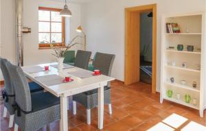 a dining room with a white table and chairs at Stunning Apartment In Limbach With 2 Bedrooms in Limbach im Burgenland