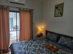 a bedroom with a bed with a tray on it at Amaretto Hostel in Surat Thani