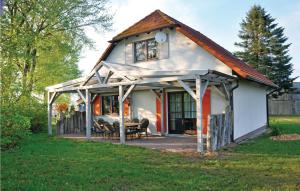 a small white house with a gambrel roof at 4 Bedroom Gorgeous Home In Fuhlendorf in Fuhlendorf
