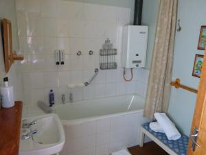 a bathroom with a bath tub and a sink at Walkerbouts Inn in Rhodes