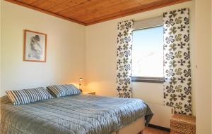 a bedroom with a bed and a window at Stunning Home In Figeholm With Kitchen in Figeholm