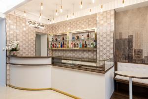 a bar in a restaurant with a table and a chair at Petit Hotel in Prato