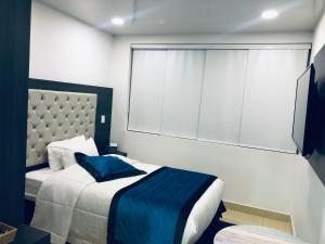 Postel nebo postele na pokoji v ubytování Hotel San Antonio Guarne
