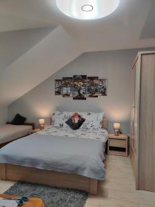 a bedroom with a king sized bed and two lamps at Apartamenty u Maksa in Reczpol