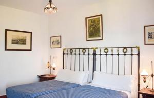 a bedroom with a blue bed with white pillows at Hotel Los Caspios in Colunga