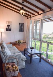 a living room with a couch and a table at Hotel Los Caspios in Colunga