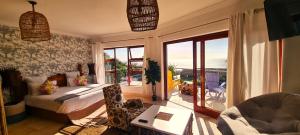 a bedroom with a bed and a view of the ocean at Beachwood Camps Bay in Cape Town