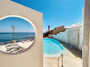 a view of the ocean from the balcony of a house at Hotel Tonnara Trabia in Trabia