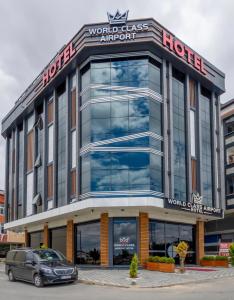 a building with a car parked in front of it at World Class Airport Hotel in Arnavutköy