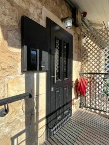 a black door on the side of a building at City Port Hotel in Haifa