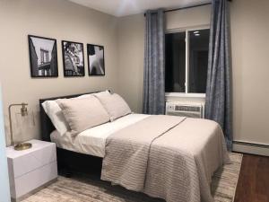 a small bedroom with a bed and a window at Oasis Stay NY, 2BR Cozy Home in a 2Family House, 18min from the City in Unionport