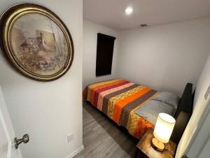 a bedroom with a bed and a mirror on the wall at Lackland-area new cozy 2BR home in San Antonio