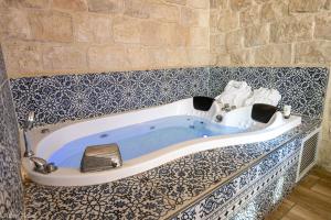 a blue and white bath tub in a room at Heart Mansion Rashbi compound in Safed +24 photos