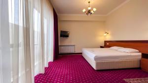 Voodi või voodid majutusasutuse Olympavan Hotel toas