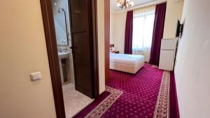 Voodi või voodid majutusasutuse Olympavan Hotel toas