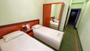 Voodi või voodid majutusasutuse Olympavan Hotel toas