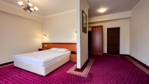 Voodi või voodid majutusasutuse Olympavan Hotel toas