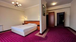 Voodi või voodid majutusasutuse Olympavan Hotel toas