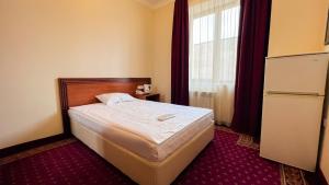 Voodi või voodid majutusasutuse Olympavan Hotel toas