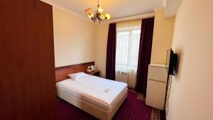 Voodi või voodid majutusasutuse Olympavan Hotel toas