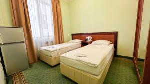 Voodi või voodid majutusasutuse Olympavan Hotel toas