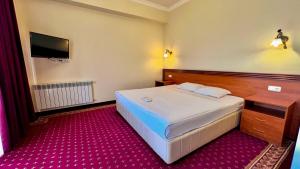 Voodi või voodid majutusasutuse Olympavan Hotel toas