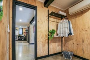 a hallway with wooden walls and a sliding glass door at Joshi’s - Dog & kid friendly guesthouse in Agnes Water