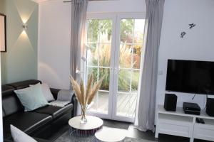 a living room with a couch and a large window at Auszeit am Meer in Zierow