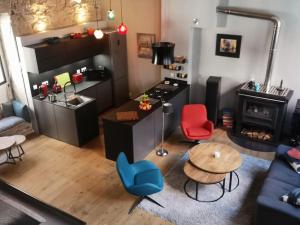 a living room with a table and chairs and a kitchen at bnbgônes - LE LOFT BODIN Croix Rousse - METRO in Lyon