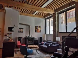 a living room with a couch and a fireplace at bnbgônes - LE LOFT BODIN Croix Rousse - METRO in Lyon