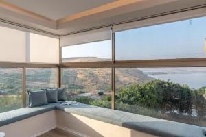 a room with a large window with views of the ocean at L.T.D luxury apartments 4 bedroom panoramic view in Tiberias