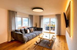 a living room with a couch and a table at Bergzauber Appartements in Rennweg