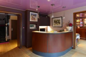 a bar in a room with a purple ceiling at Urban Style hotel de l'Europe in Rouen