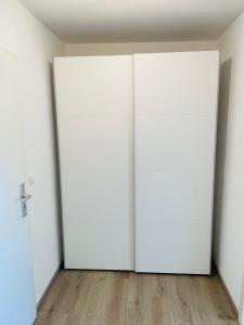 an open door in an empty room with wooden floors at Zollernalb-Apartment MG in Albstadt