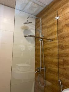 a shower with a glass door in a bathroom at Khách sạn Hương Mê in Buon Ma Thuot