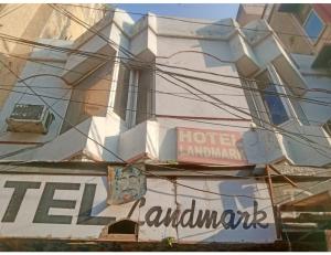 a building with a sign on the side of it at Hotel Landmark Lodge, Jammu in Jammu