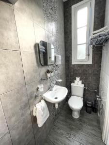 a bathroom with a toilet and a sink at COSY Apartment in La Marsa Corniche - Beach in La Marsa