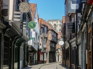 an alley with buildings and signs on the side of a street at Middlecroft in York